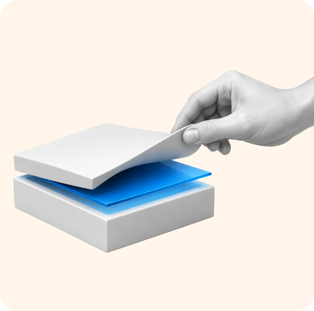 A hand lifting the top sheet from a stack of papers, revealing blue layers underneath